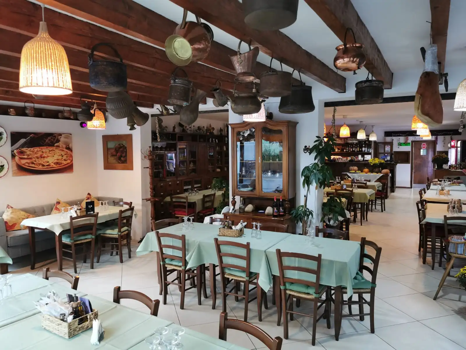 The dining room at Trattoria Al Gallo, with tables set for guests